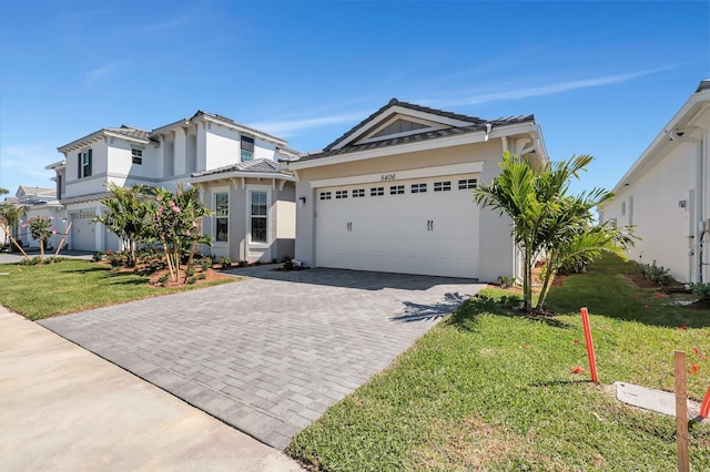 view of front of home with a front yard and a garage