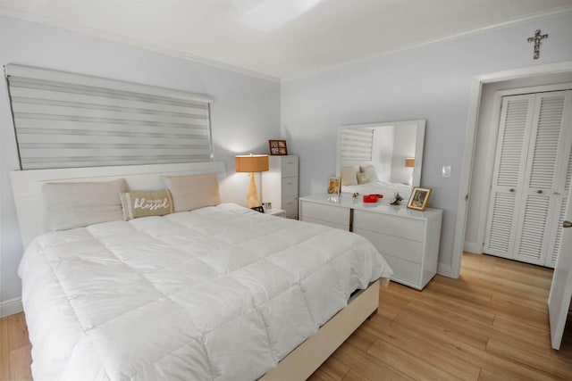 bedroom with baseboards, light wood-style floors, and ornamental molding