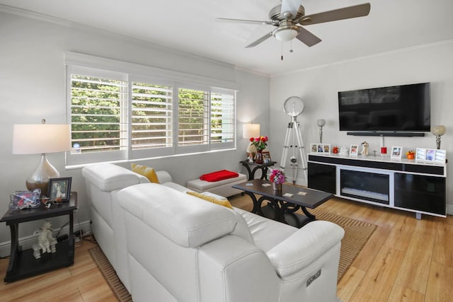 living room with a ceiling fan, wood finished floors, and crown molding