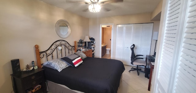 bedroom featuring a closet, ceiling fan, light tile patterned floors, and ensuite bathroom