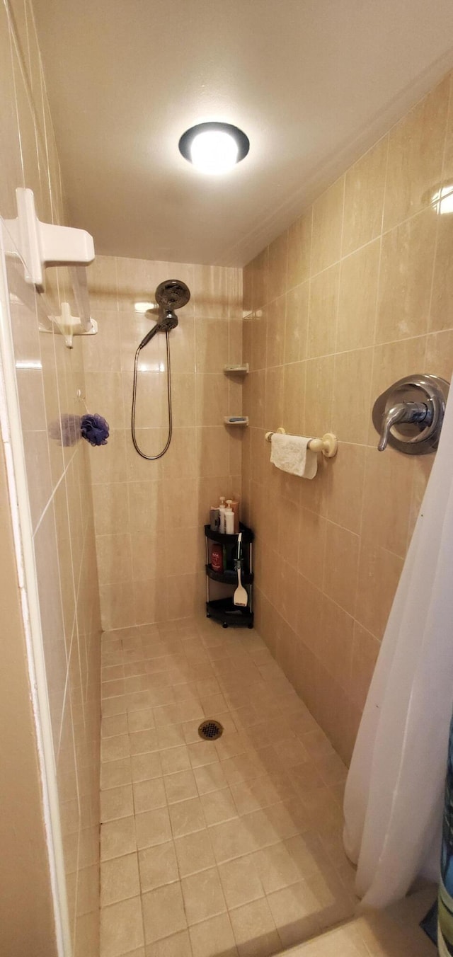 bathroom with tile patterned flooring, tile walls, and a shower with curtain