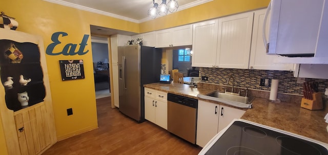 kitchen featuring hardwood / wood-style floors, appliances with stainless steel finishes, white cabinetry, and sink