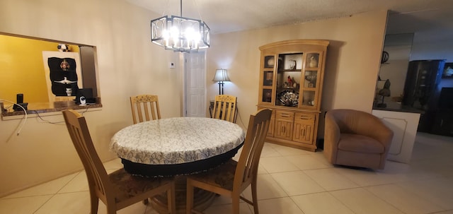 dining space with a notable chandelier and light tile patterned floors