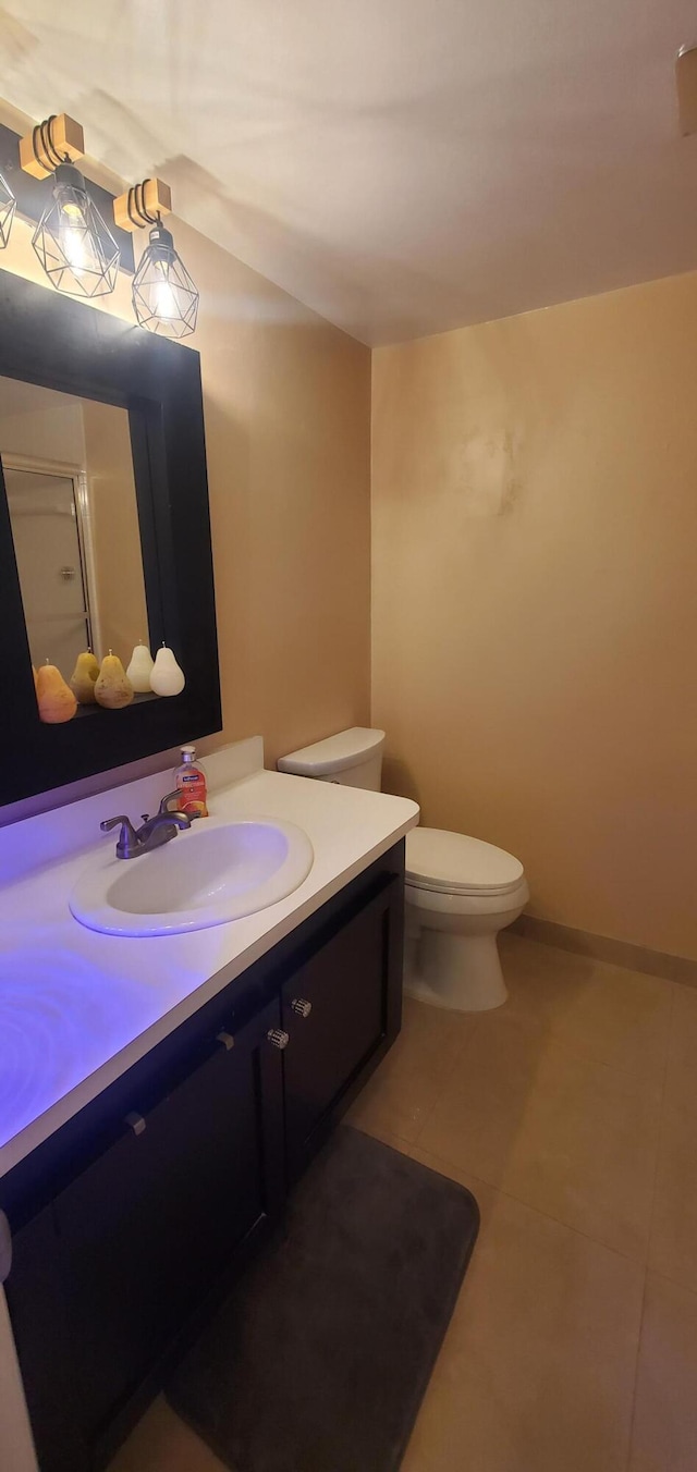 bathroom with tile patterned floors, toilet, a shower with door, and vanity