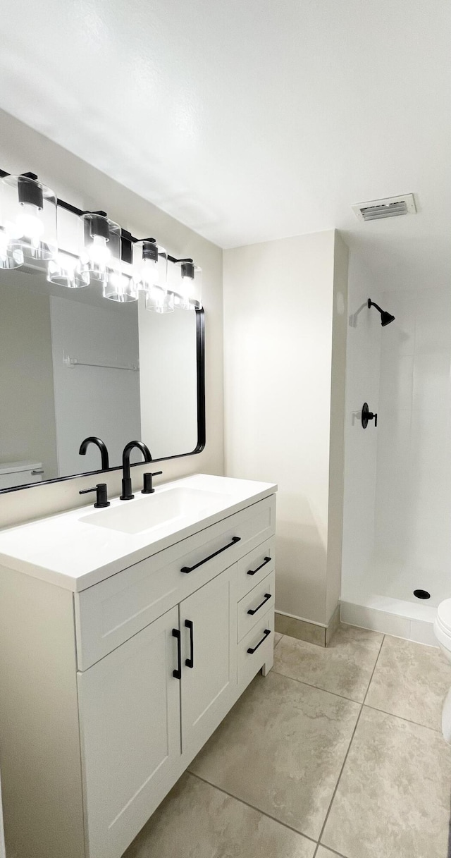 full bath featuring vanity, visible vents, walk in shower, tile patterned floors, and toilet