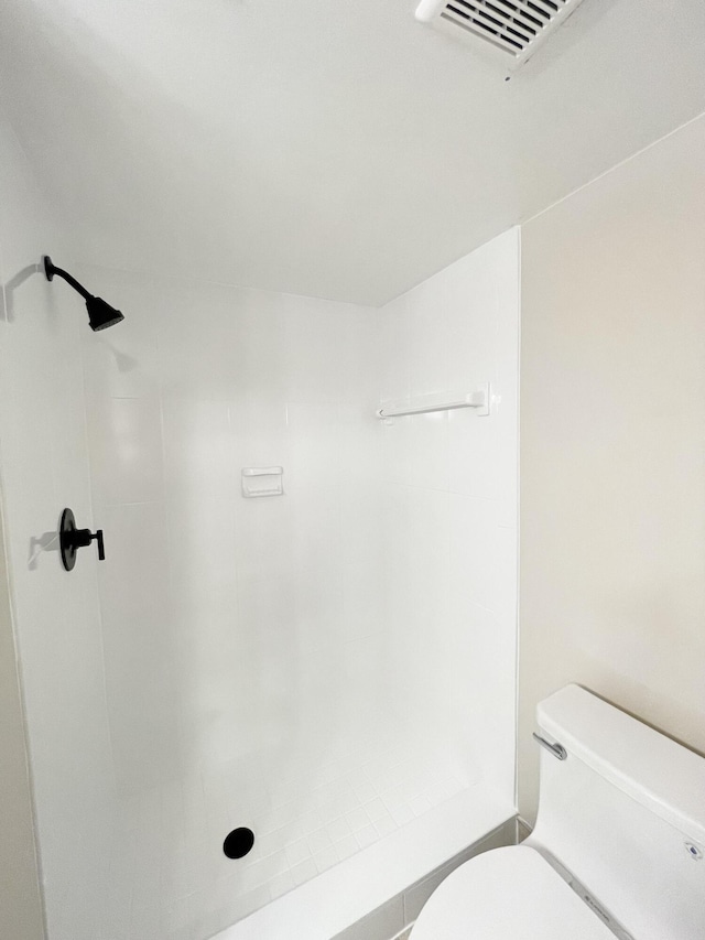 full bath featuring visible vents, toilet, and a shower