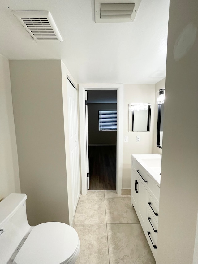 bathroom featuring vanity, toilet, and hardwood / wood-style floors