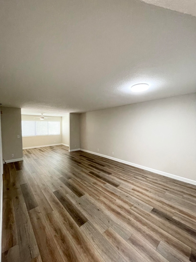 interior space with a textured ceiling and wood-type flooring