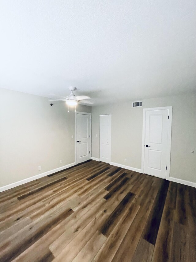 empty room with ceiling fan and hardwood / wood-style flooring