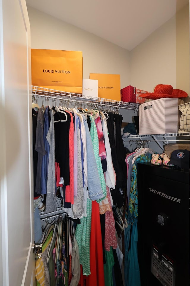 walk in closet with lofted ceiling