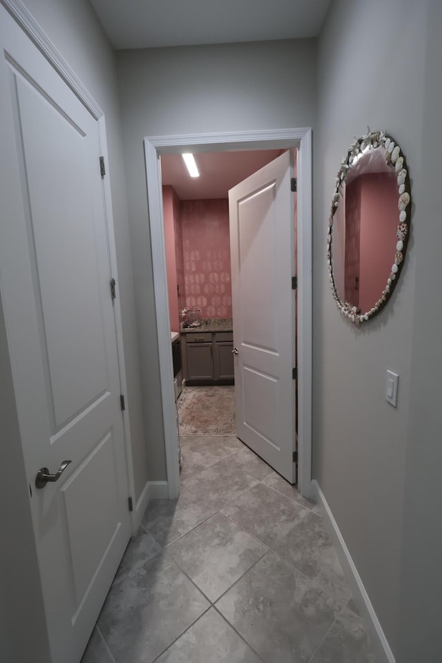 hall featuring light tile patterned floors