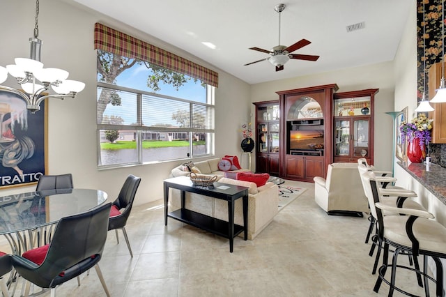 living room featuring ceiling fan with notable chandelier