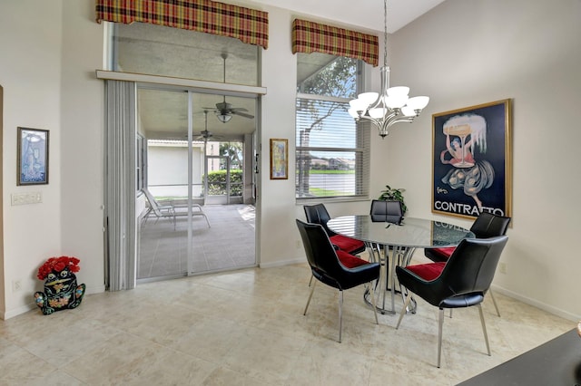 dining room with high vaulted ceiling and ceiling fan with notable chandelier