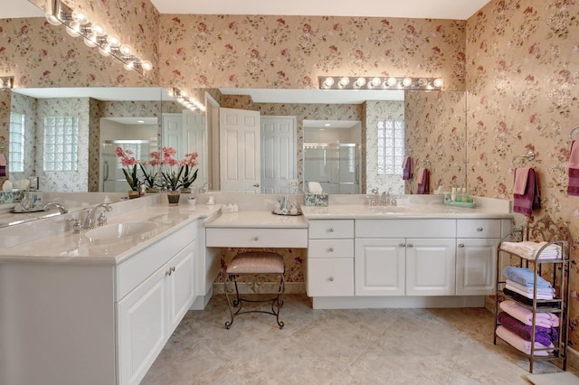 bathroom with a shower with door and vanity