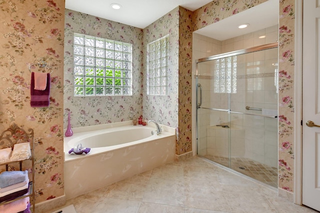 bathroom featuring tile patterned flooring and shower with separate bathtub