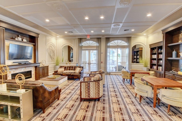 interior space featuring french doors, built in shelves, light colored carpet, coffered ceiling, and ornamental molding