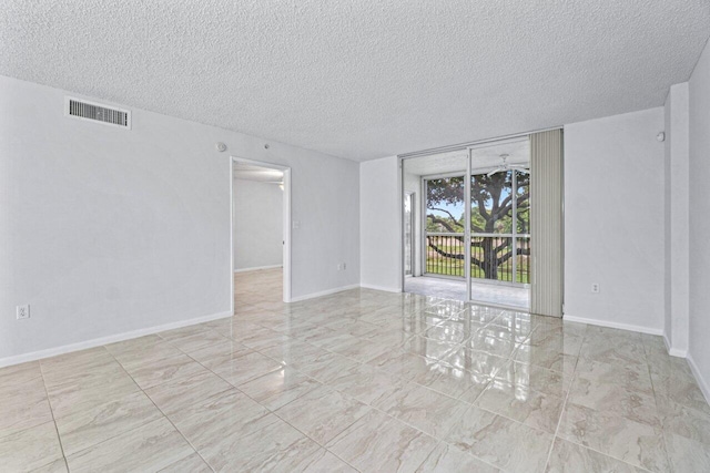 spare room with a textured ceiling