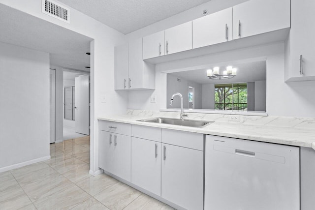 kitchen featuring white dishwasher, a chandelier, white cabinetry, sink, and a textured ceiling