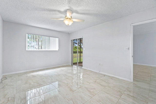 spare room with ceiling fan and a textured ceiling