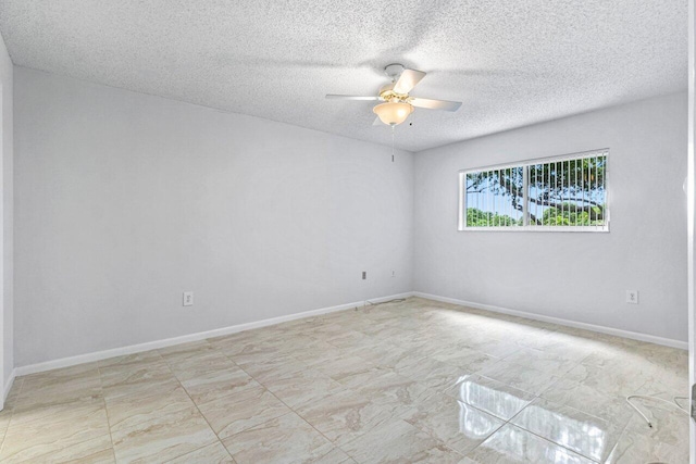 empty room with a textured ceiling and ceiling fan