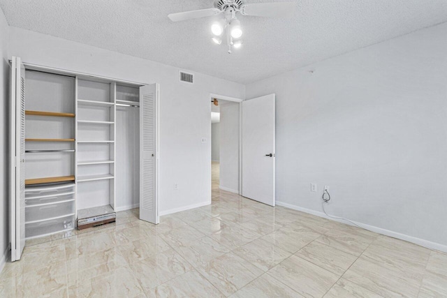 unfurnished bedroom featuring a textured ceiling, ceiling fan, and a closet