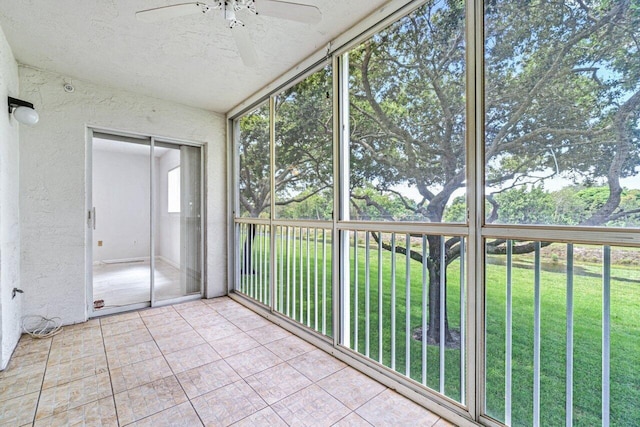 unfurnished sunroom with ceiling fan