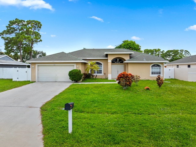 single story home with a garage and a front yard