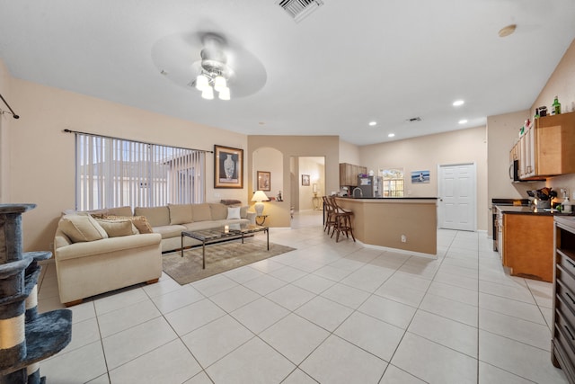 tiled living room with ceiling fan