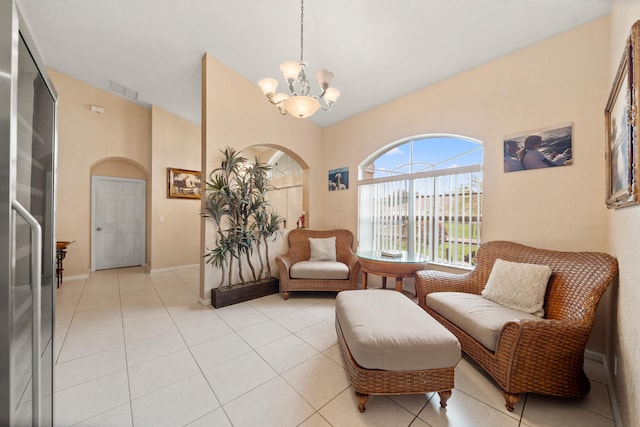 sitting room with a chandelier and light tile patterned floors