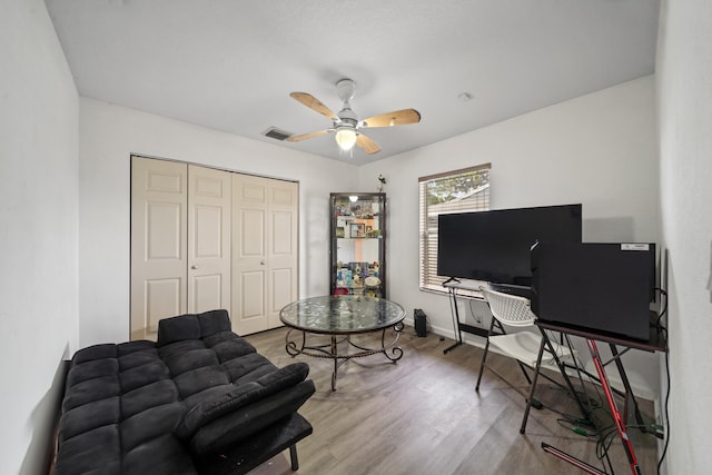 living room featuring ceiling fan and wood-type flooring