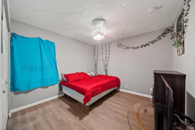 bedroom with ceiling fan and light hardwood / wood-style floors