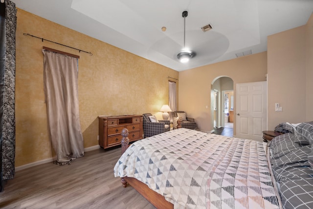 bedroom with ceiling fan and hardwood / wood-style flooring