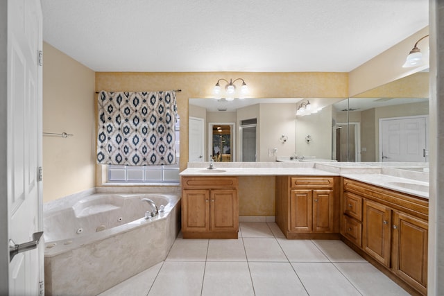 bathroom featuring tile patterned flooring, separate shower and tub, a textured ceiling, and vanity