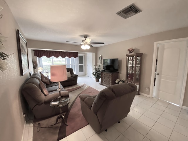 living room with ceiling fan and light tile patterned floors