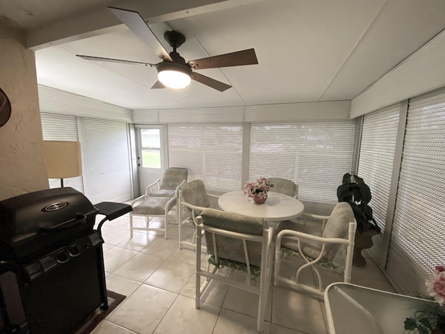 dining space with vaulted ceiling, light tile patterned flooring, and ceiling fan