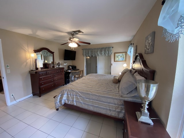 tiled bedroom with multiple windows and ceiling fan