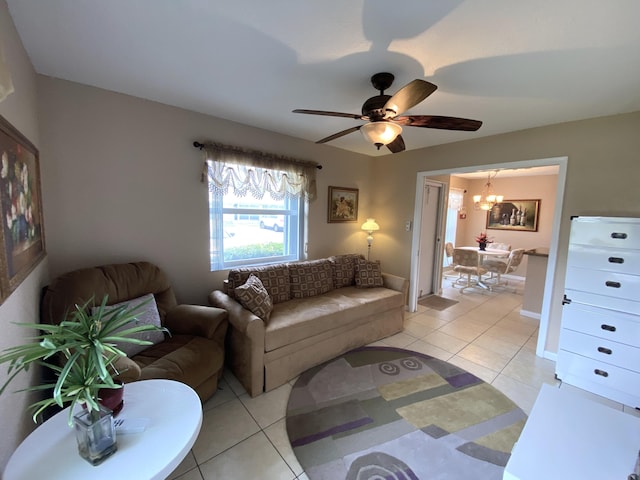 tiled living room featuring ceiling fan with notable chandelier