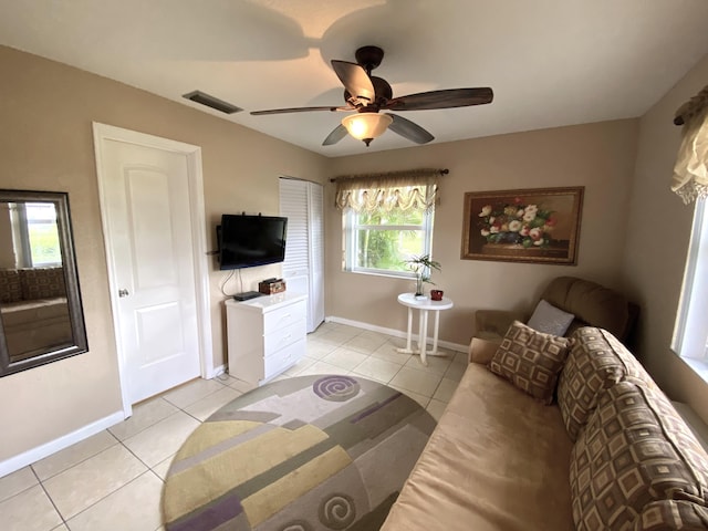 living room with ceiling fan and light tile patterned floors