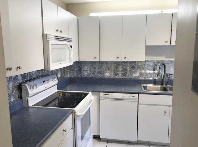 kitchen with white cabinets, white appliances, and tasteful backsplash