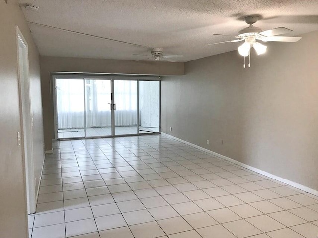 tiled spare room with ceiling fan and a textured ceiling