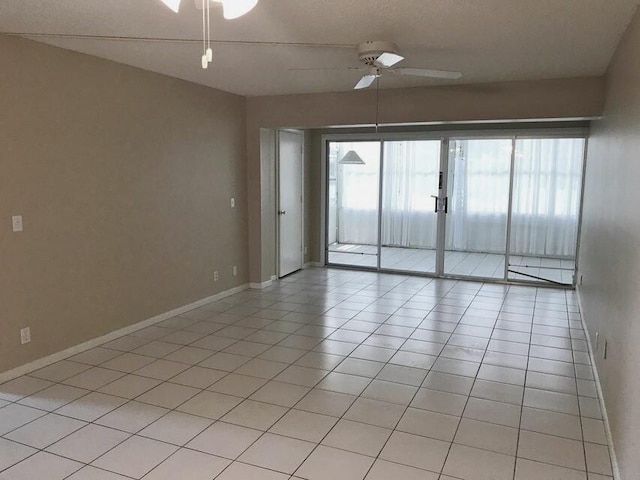 unfurnished room with ceiling fan, plenty of natural light, and light tile patterned flooring