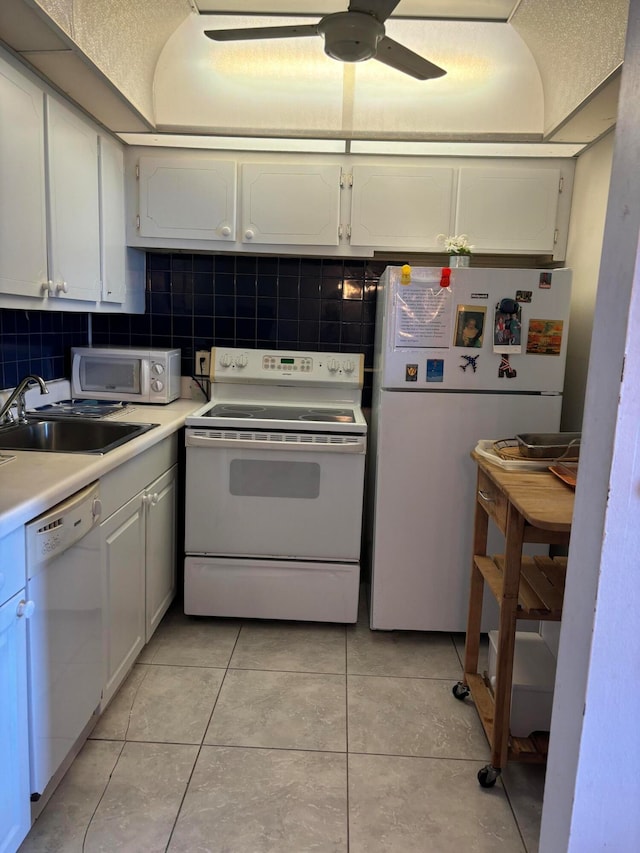 kitchen featuring white cabinets, white appliances, ceiling fan, and tasteful backsplash