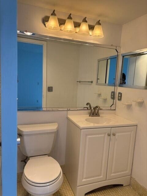 bathroom with tile patterned floors, vanity, and toilet