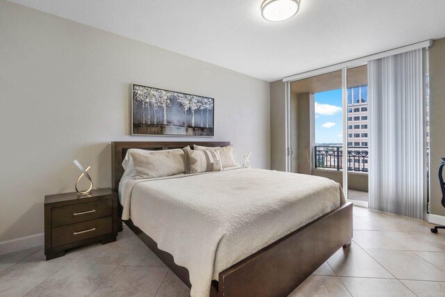 tiled bedroom featuring access to outside and expansive windows