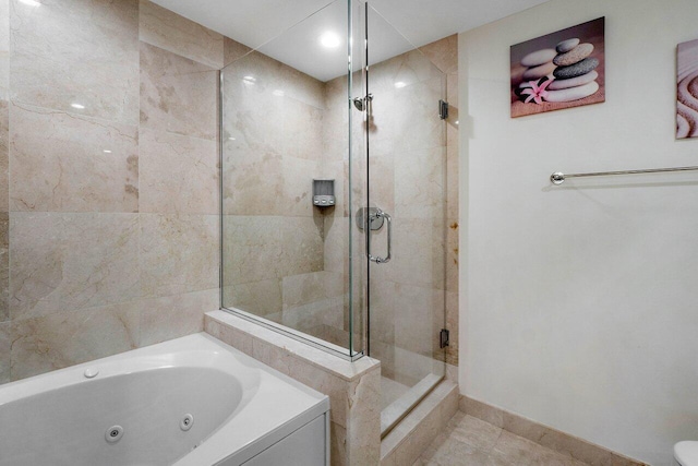 bathroom featuring tile patterned flooring and independent shower and bath