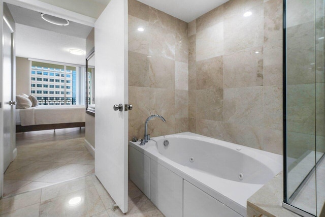 bathroom with a washtub and tile patterned flooring