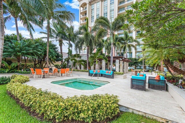 view of pool featuring outdoor lounge area, an in ground hot tub, and a patio