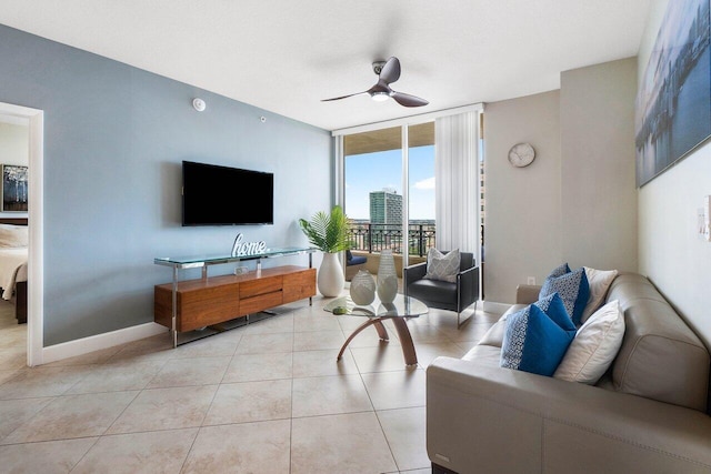 tiled living room with floor to ceiling windows and ceiling fan