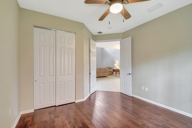 6716 Eagle Ridge Dr, Greenacres, FL 33413 - unfurnished bedroom with visible vents, baseboards, a closet, and wood finished floors