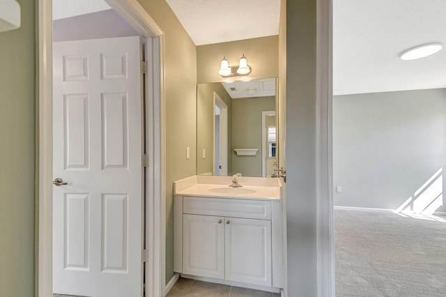 bathroom featuring a textured ceiling and vanity